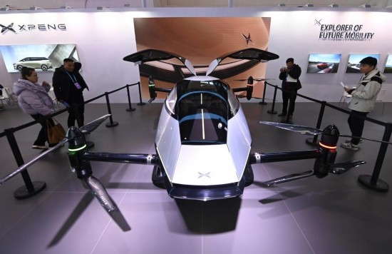 2023年12月1日，在鏈博會智能汽車鏈展區(qū)小鵬汽車展臺，參觀者觀看一臺智能飛行器。新華社記者蔡湘鑫攝