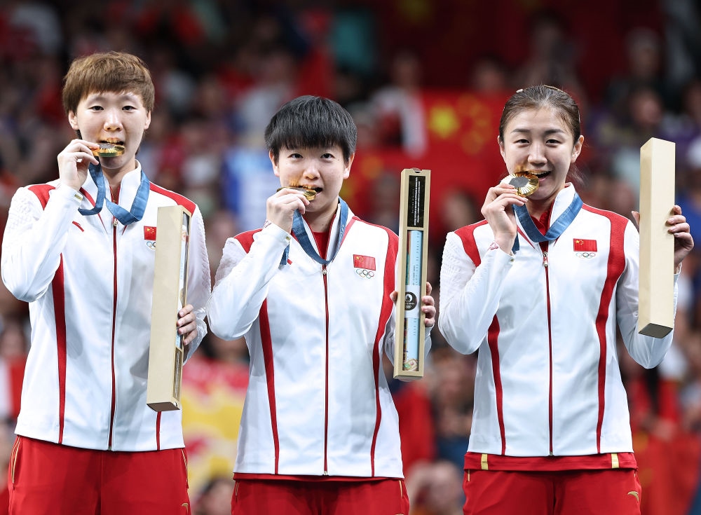 冠軍中國隊選手王曼昱、孫穎莎、陳夢（從左至右）在巴黎奧運會乒乓球女子團體頒獎儀式上（2024年8月10日攝）。新華社記者 王東震 攝