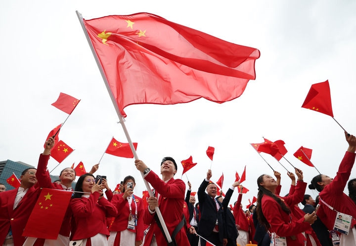 2024年7月26日，在法國巴黎舉行的第33屆夏季奧林匹克運(yùn)動(dòng)會(huì)開幕式正式開始前，中國體育代表團(tuán)旗手揮舞國旗。新華社記者 曹燦 攝