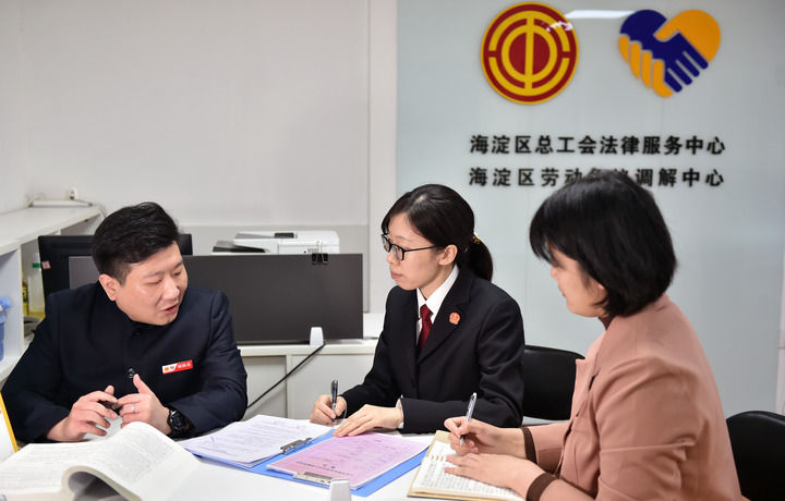 2025年3月6日，在北京市海淀區(qū)總工會勞動爭議調(diào)解中心，海淀區(qū)人民法院法官王琰（中）與該中心工作人員就糾紛化解情況進行溝通。新華社記者 趙婷婷 攝